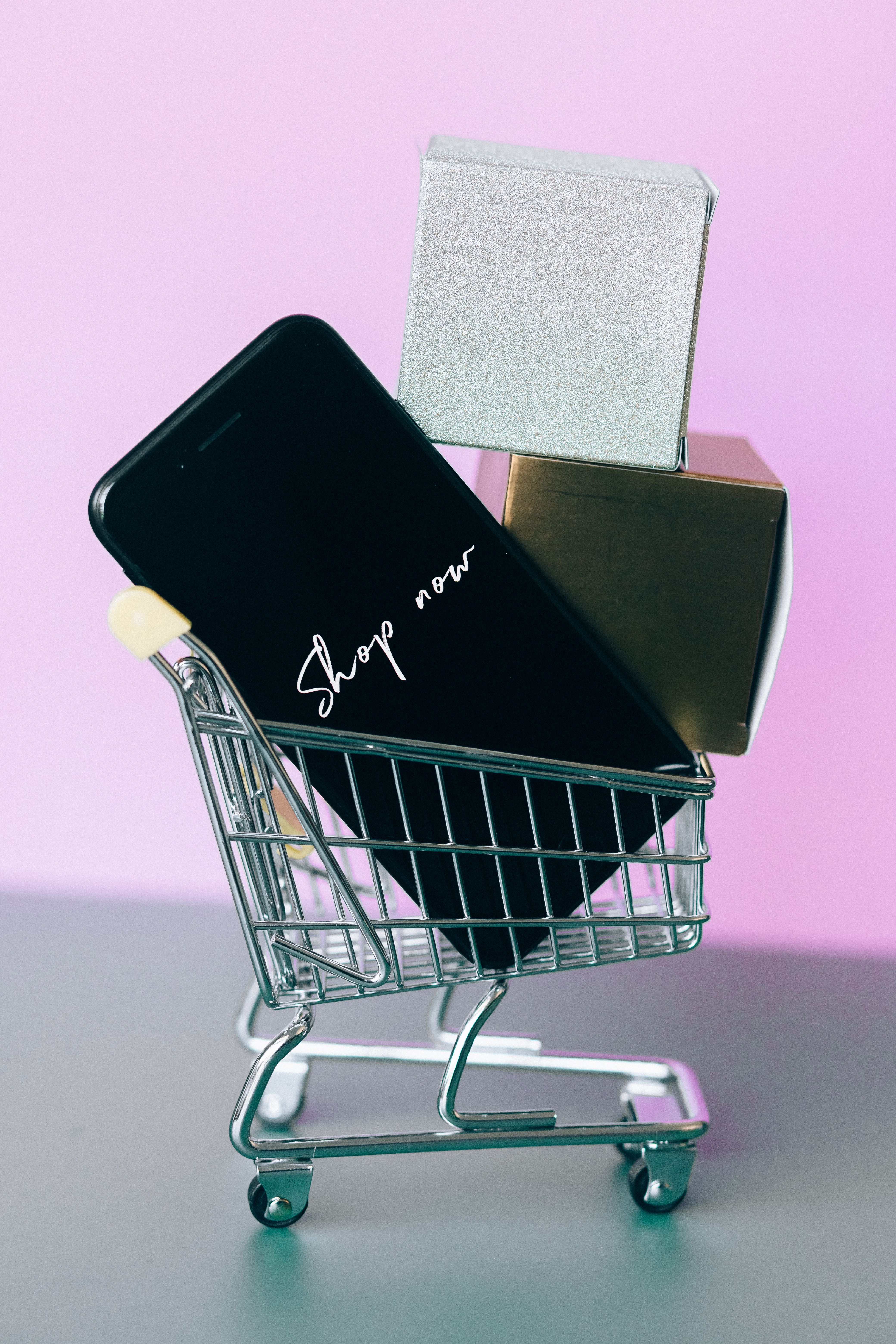 Smartphone showing 'Shop now' in a small pink shopping cart