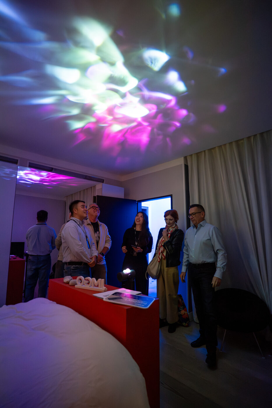 Portable JMGO projector demonstrated in a living room